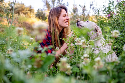 Woman with dog on field