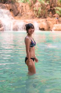 Portrait of young woman in lake