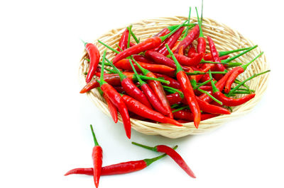 Close-up of red chili peppers over white background