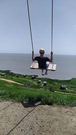 Man in sea against sky