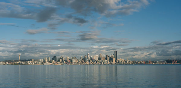 Panoramic view of sea and buildings against sky