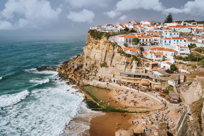 High angle view of sea and buildings against sky