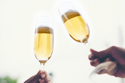 Cropped hand of people toasting champagne