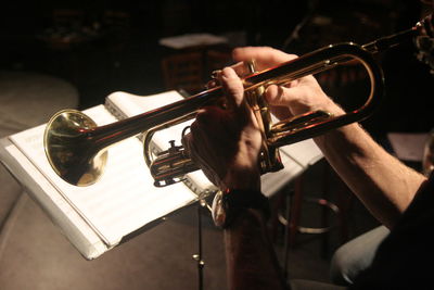 Cropped hand of musician playing trumpet