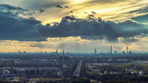 High angle view of buildings against cloudy sky