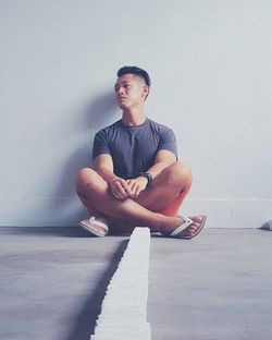 Woman sitting on wooden floor