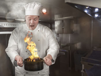 Chef holding container with fire