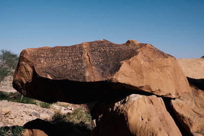 Rock formations against clear blue sky