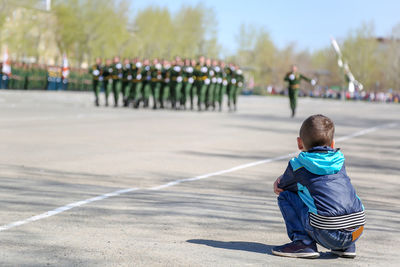 Rear view of boy on road