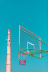 Low angle view of windmill against blue sky