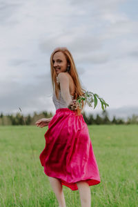 Beautiful young woman running on plants