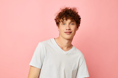 Portrait of young man against yellow background