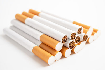 Close-up of cigarettes on white background