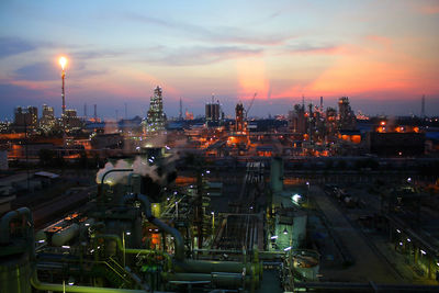 High angle view of illuminated cityscape against sky during sunset