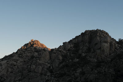 Low angle view of rock formation against clear sky