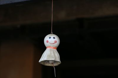 Close-up of stuffed toy hanging on wood