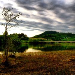 Scenic view of lake against cloudy sky