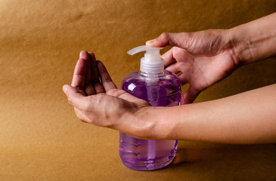 Close-up of hand holding water bottle