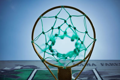 Low angle view of basketball hoop against clear blue sky