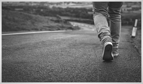 Low section of man standing on street