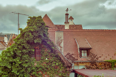 Exterior of house by building against sky