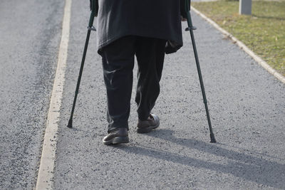 Low section of man walking on footpath