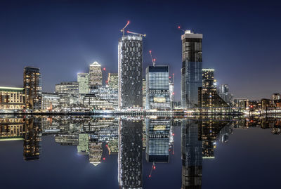 Reflection of buildings in city at night