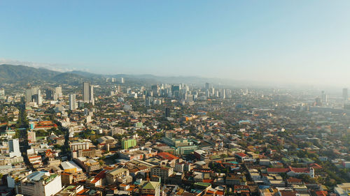 High angle view of modern buildings in city against clear sky