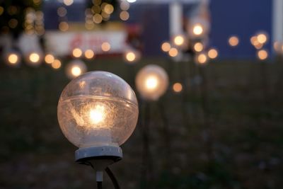 Close-up of illuminated light bulb at night