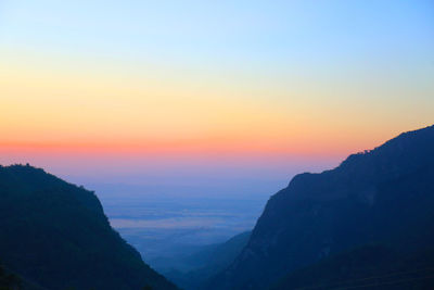 Scenic view of silhouette mountains against sky during sunset