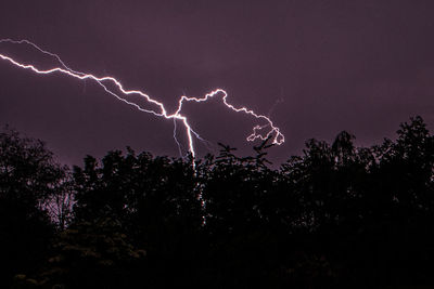 Low angle view of lightning against sky at night