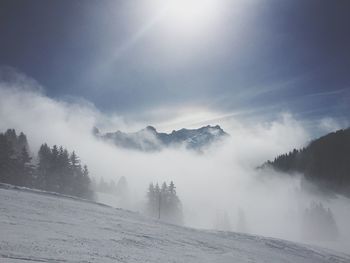 Scenic view of mountains against cloudy sky