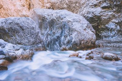River flowing through rocks during winter