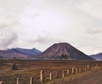 Scenic view of field and mountains against sky