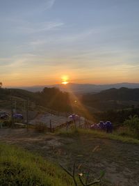 Scenic view of field against sky during sunset