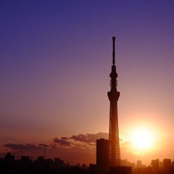 Silhouette of communications tower at sunset