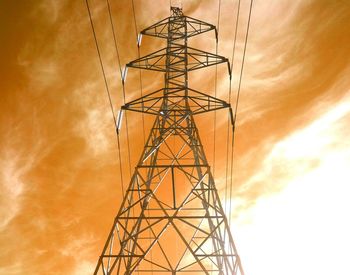 Low angle view of power lines against cloudy sky