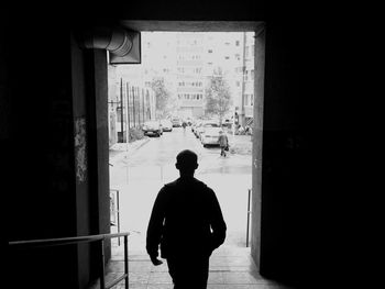 Rear view of silhouette man walking in corridor