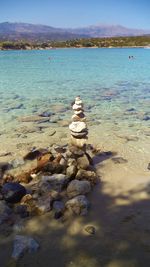 Close-up of rocks on beach against sky
