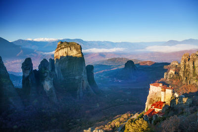 Panoramic view of mountain range against blue sky