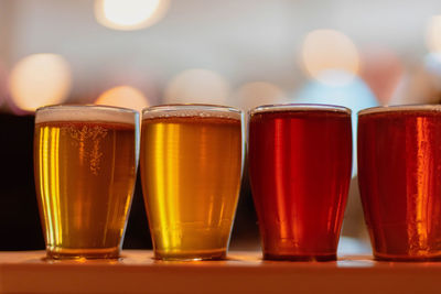 Close-up of beer glasses on table