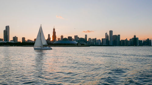 Scenic view of cityscape against clear sky during sunset