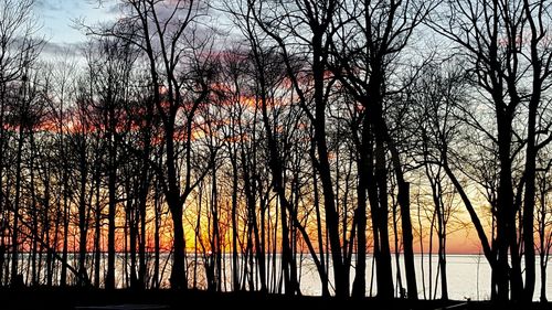 Scenic view of river against sky at dusk