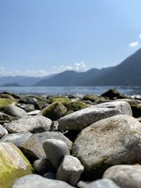 Stones on beach against sky