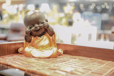 Close-up of boy sitting on table