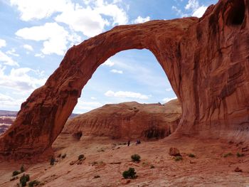 Rock formation by mountains at arches national park against sky