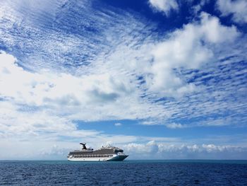 Ship sailing in sea against sky