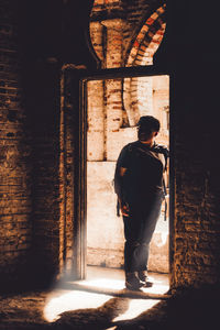 Man standing at entrance of building