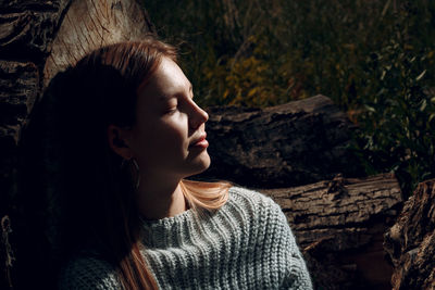 Close-up portrait of young woman with eyes closed