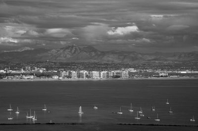 High angle view of townscape by sea against sky